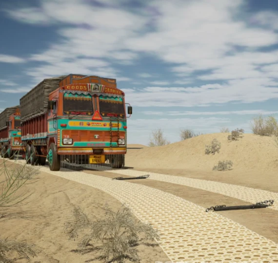 A truck crossing SkandPath assault trackway during a desert trial